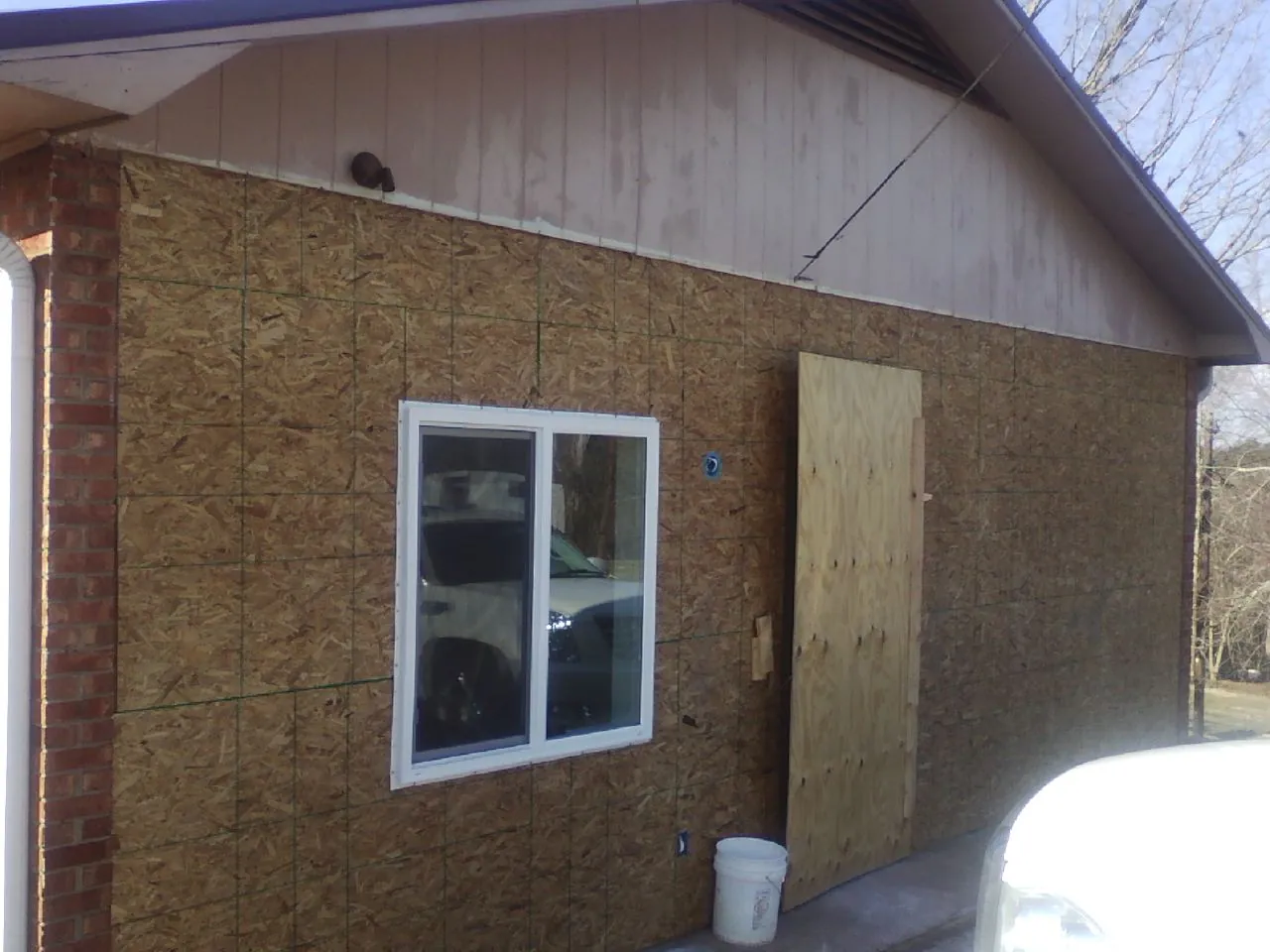 OSB sheathing on a garage addition wall before siding in Parachute